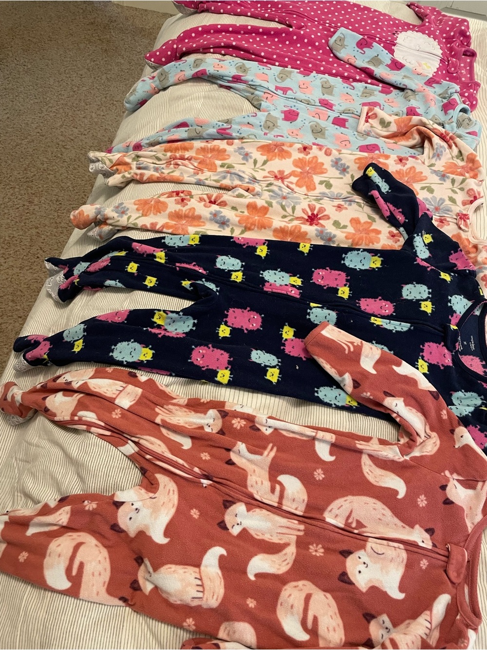 Five 3T Carter’s Girls' Assorted Print Footed Pajamas.